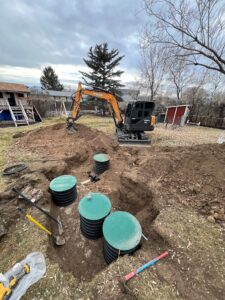 Excavator installing a residential septic system in Helena, MT